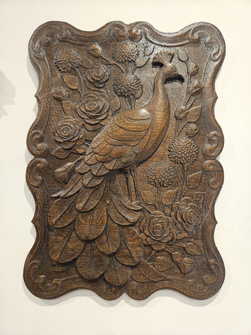 A lively peacock with floral pattern. Carved from upcycled oak floorboard. Finished with Danish oil.